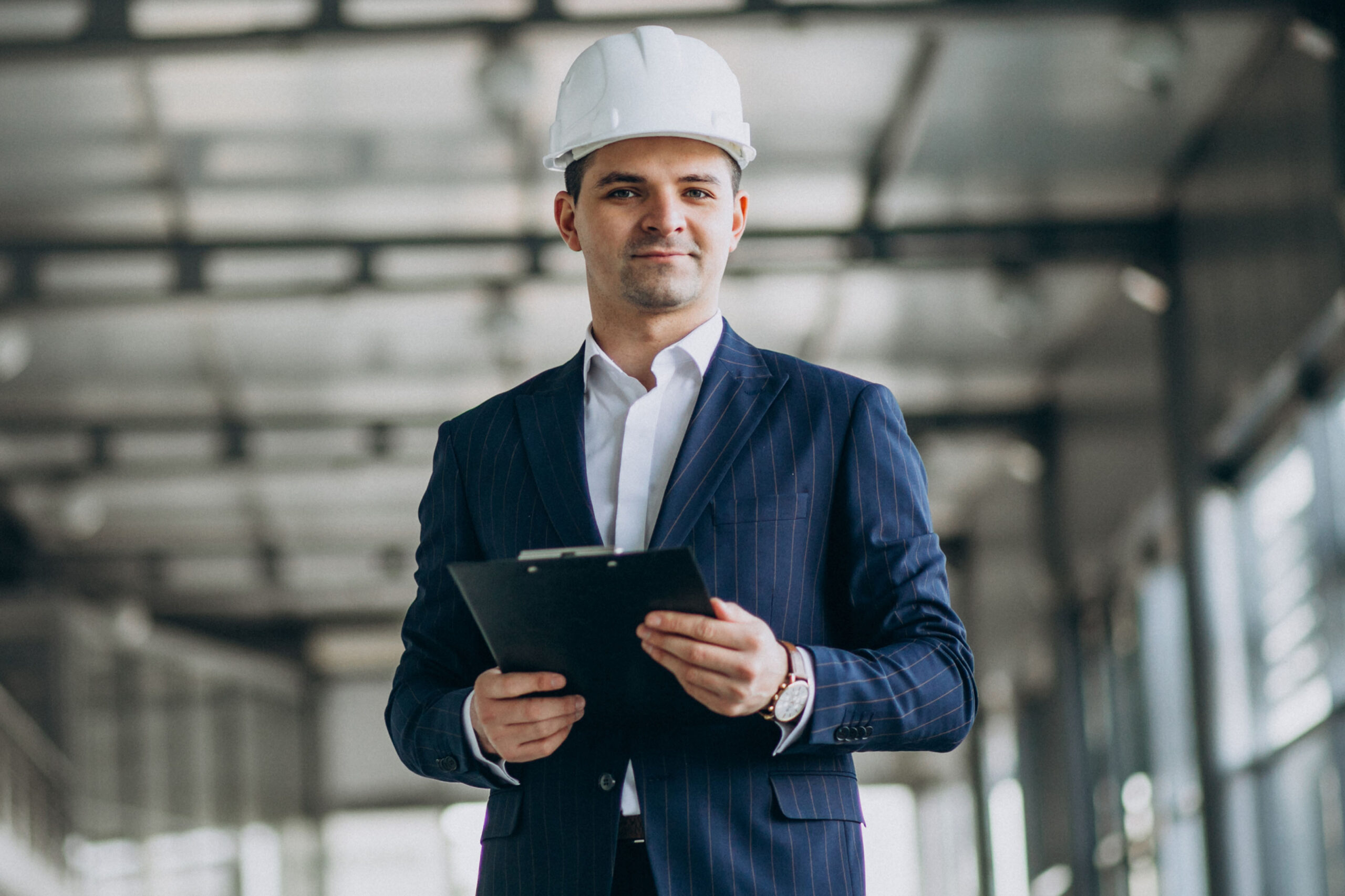 Handsome business man engineer in hard hat in a building